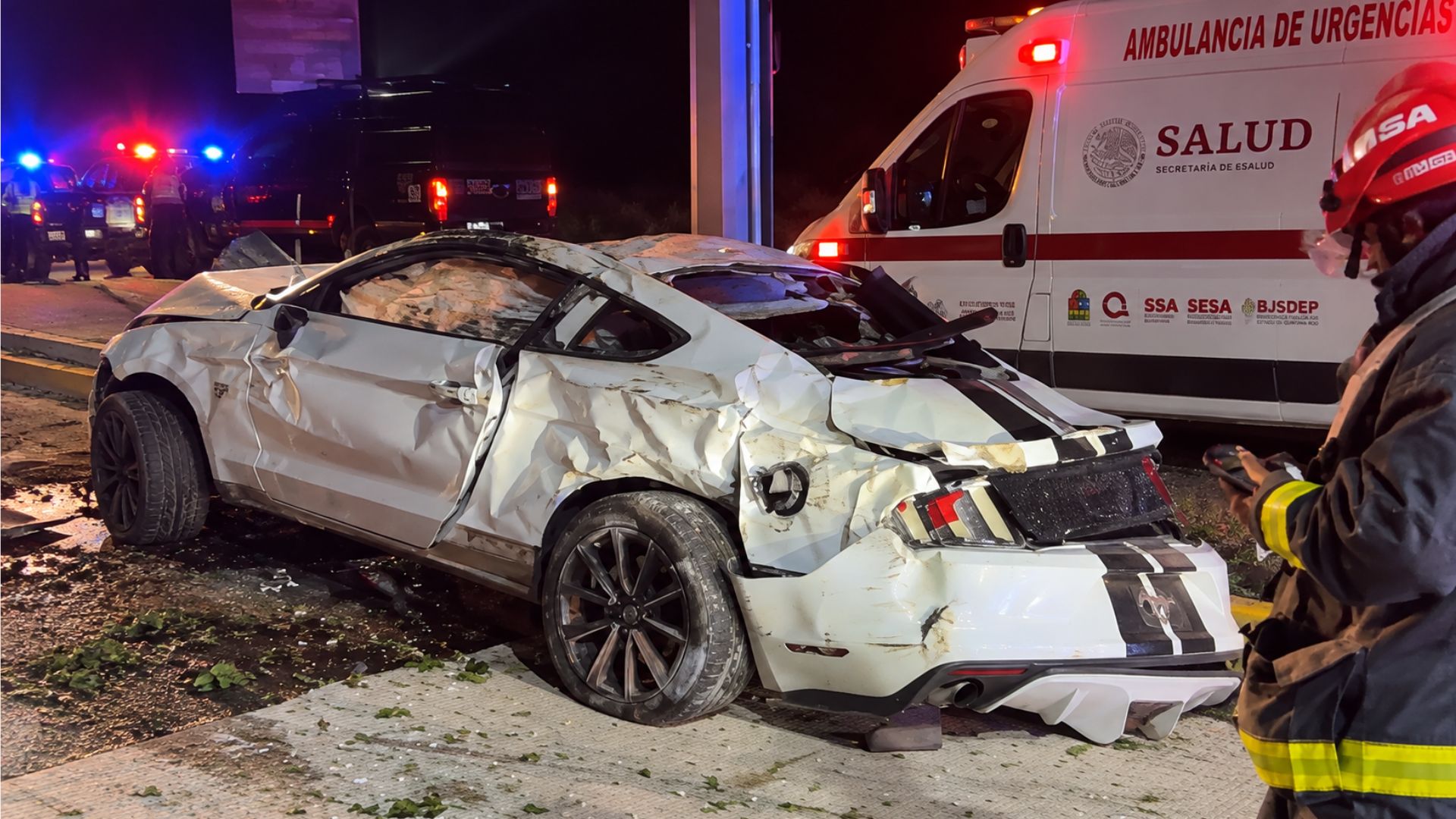 Mustang blanco con daños severos en la parte lateral y trasera después de chocar en Playa del Carmen