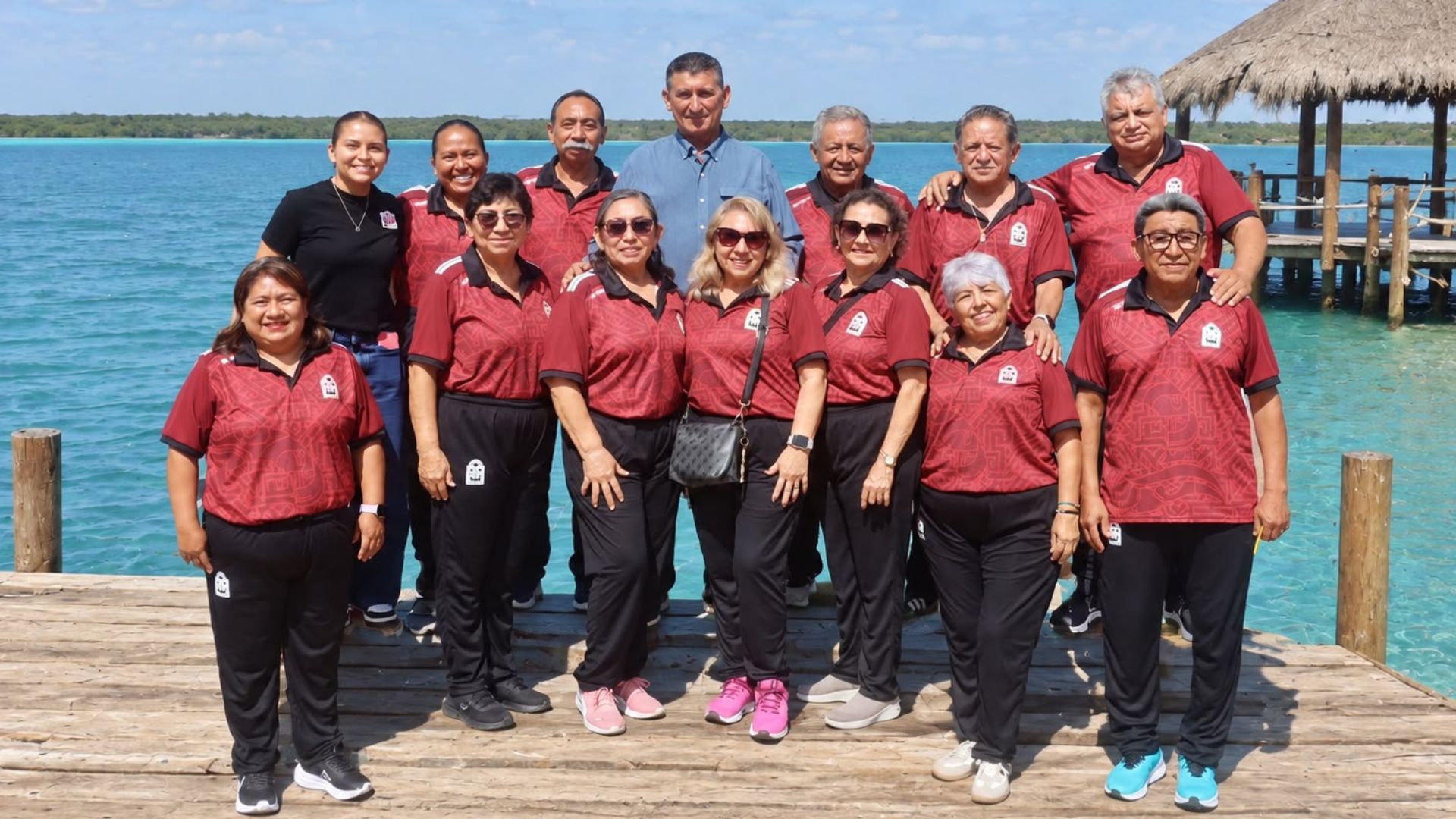 Integrantes del equipo Nuevo Salamanca de Bacalar posan con sus uniformes deportivos junto a la Laguna de los Siete Colores, previo a la Copa Edad de Oro nacional.